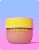 DAISE Pineapple Glow exfoliating body scrub container on a gradient background